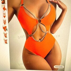 Orange one piece bathing suit with cut outs and chain detail